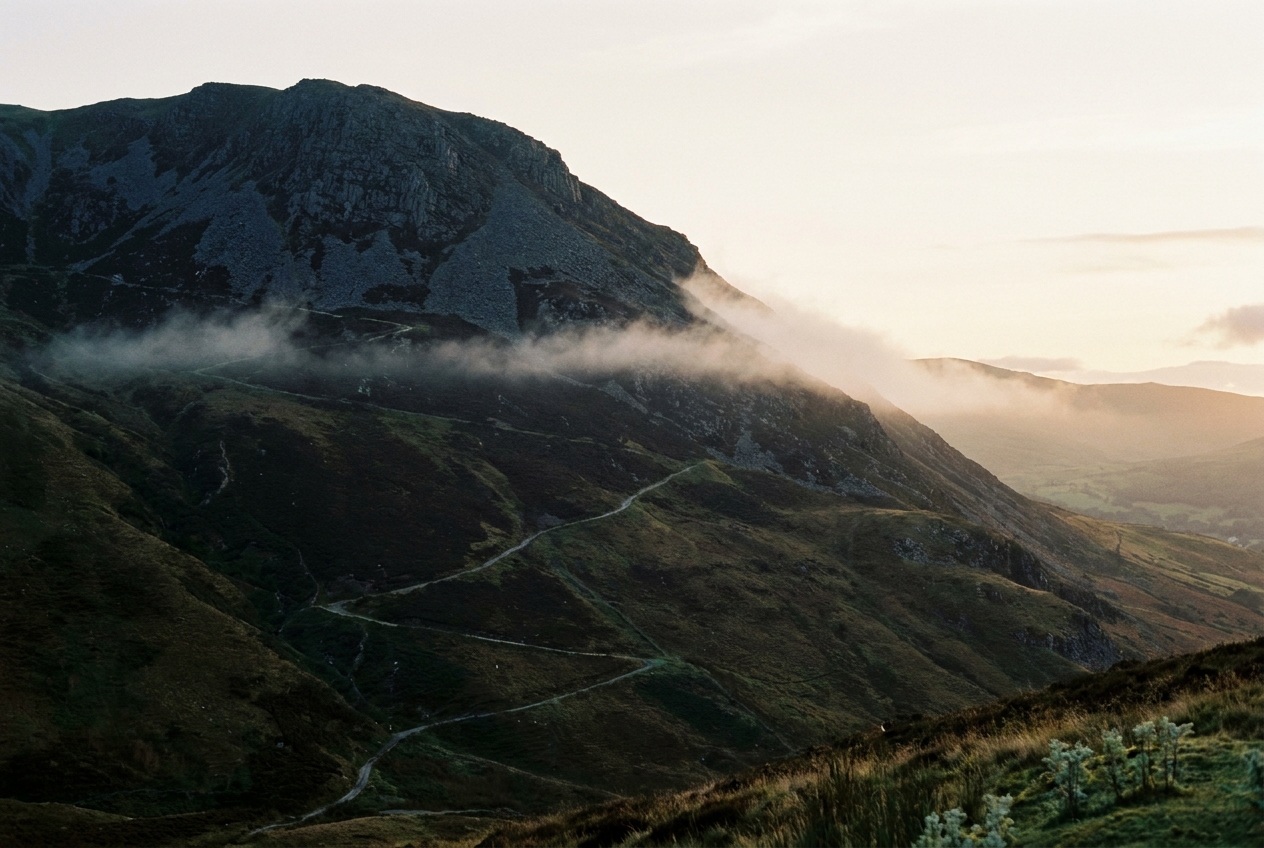 The dark shoulder of Elidir Fawr above Deiniolen at golden hour.